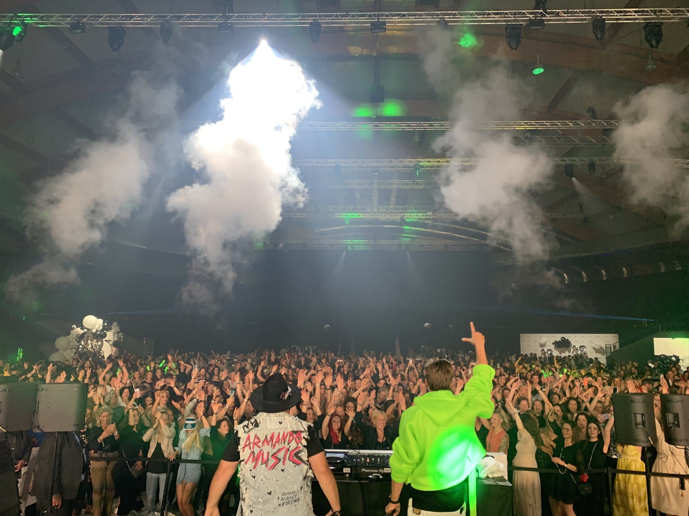 Armando performing on stage under pyro and smoke